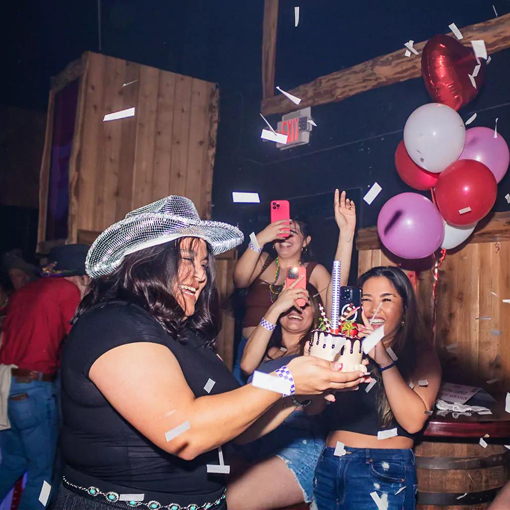 Friends celebrating a birthday at Stampede Houston nightclub