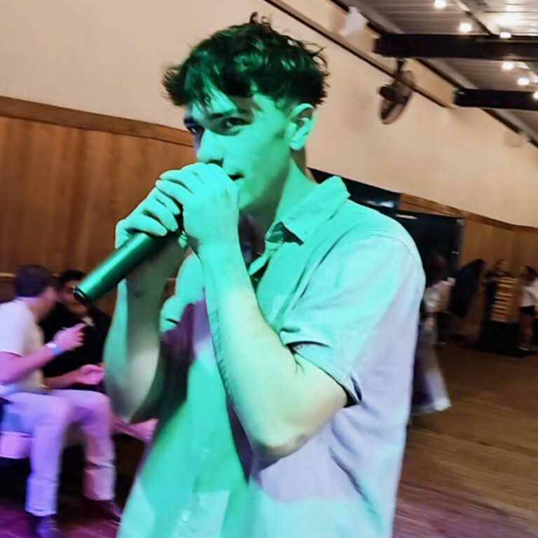 Person holding a mic on Stampede’s outdoor patio