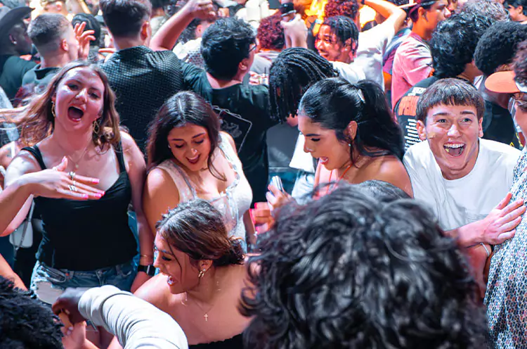 People dancing under club lights in VIBES at Stampede Houston